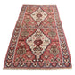Angled perspective view of Kurdish Senneh kilim rug showing full design and borders
