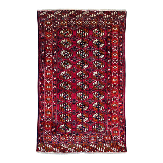 Vintage Turkmen Tekke Buhara carpet full view with traditional guls and rich red tones